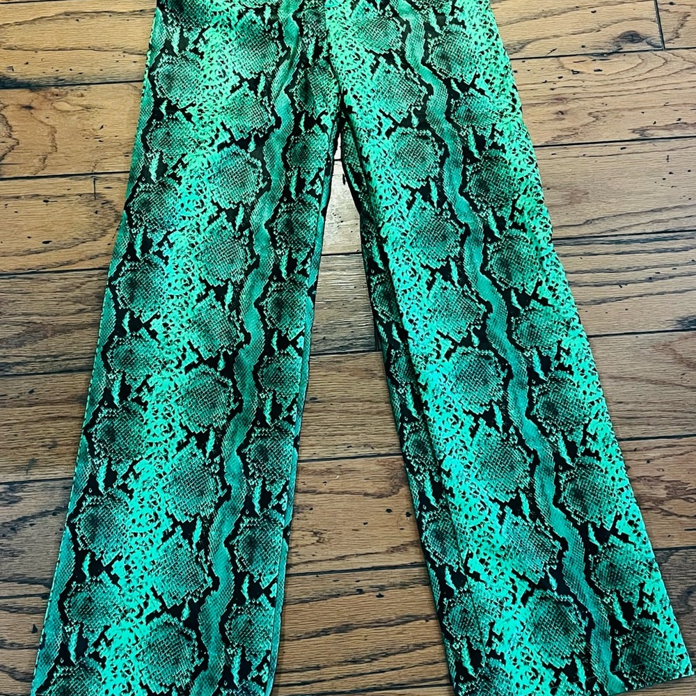 Green snakeskin print flare faux leather pants.